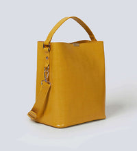 Load image into Gallery viewer, Mustard yellow vegan leather shoulder bag photographed against a white background.
