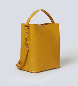 Mustard yellow vegan leather shoulder bag  photographed against a white background.