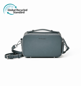 Teal blue vegan leather crossbody bag with silver hardware and the Global Recycled Standard logo photographed against a white background.