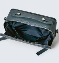 Load image into Gallery viewer, Teal vegan leather crossbody bag showing recycled blue plastic lining and silver hardware photographed against a white background.
