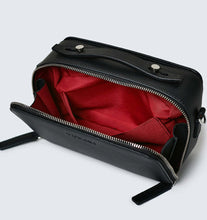 Load image into Gallery viewer, Black vegan leather crossbody bag showing recycled red plastic lining photographed against a white background.
