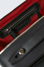 Load image into Gallery viewer, Black vegan leather crossbody bag showing recycled red plastic lining and silver zip photographed against a white background.
